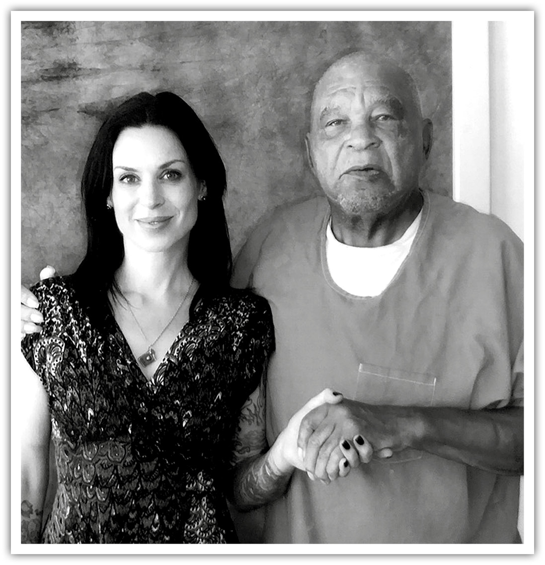 A photo of the author, Jillian Lauren, posing with Samuel Little. They are holding hands. 