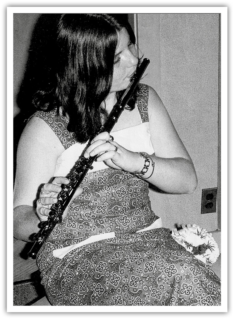 A photo of Melina LaPree playing the flute.