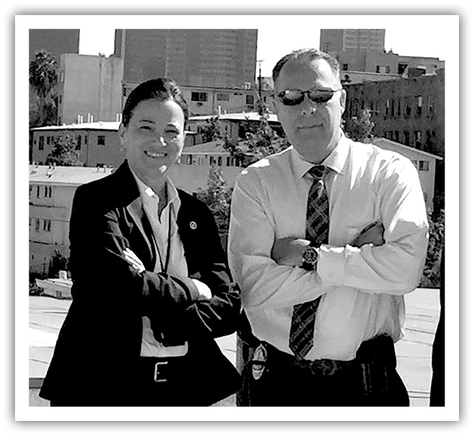 A photo of Robbery Homicide Division Cold Case Special Section Detective Mitzi Roberts and Los Angeles Police Department Detective Tim Marcia.